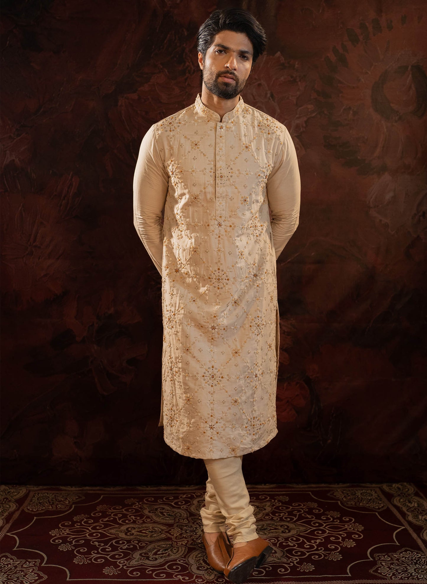 Beige Silk Kurta with all over hand done french knot embroidery with mustard and maroon highlights. Comes with Churidar.