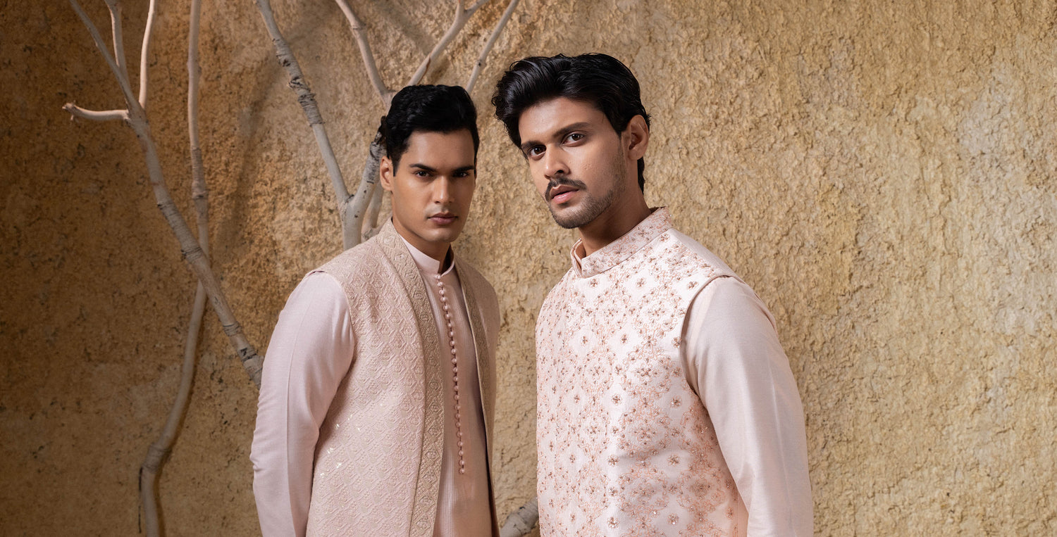 Two men in traditional attire wearing men''s kurta pajama and jacket.