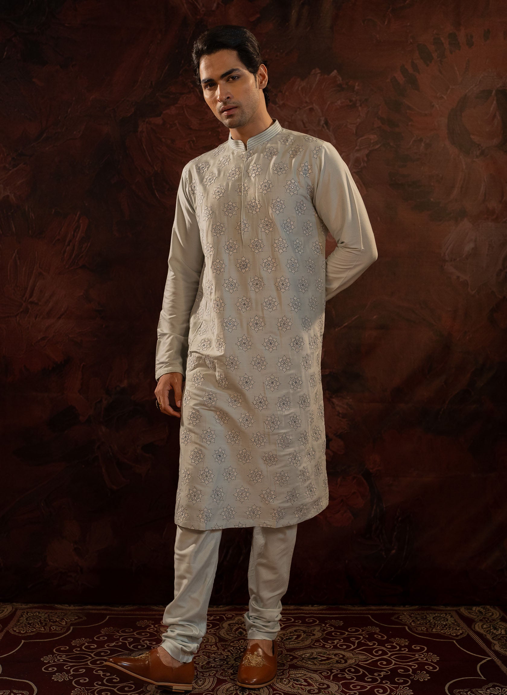 Powder blue cotton silk kurta set with floral embroidered motifs all over. Stitchline detailing on the collar. Comes with churidar.