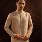 Pearl Pintuck Kurta with beige fabric mesh. Comes with straight pants with two side pockets and zip opening.