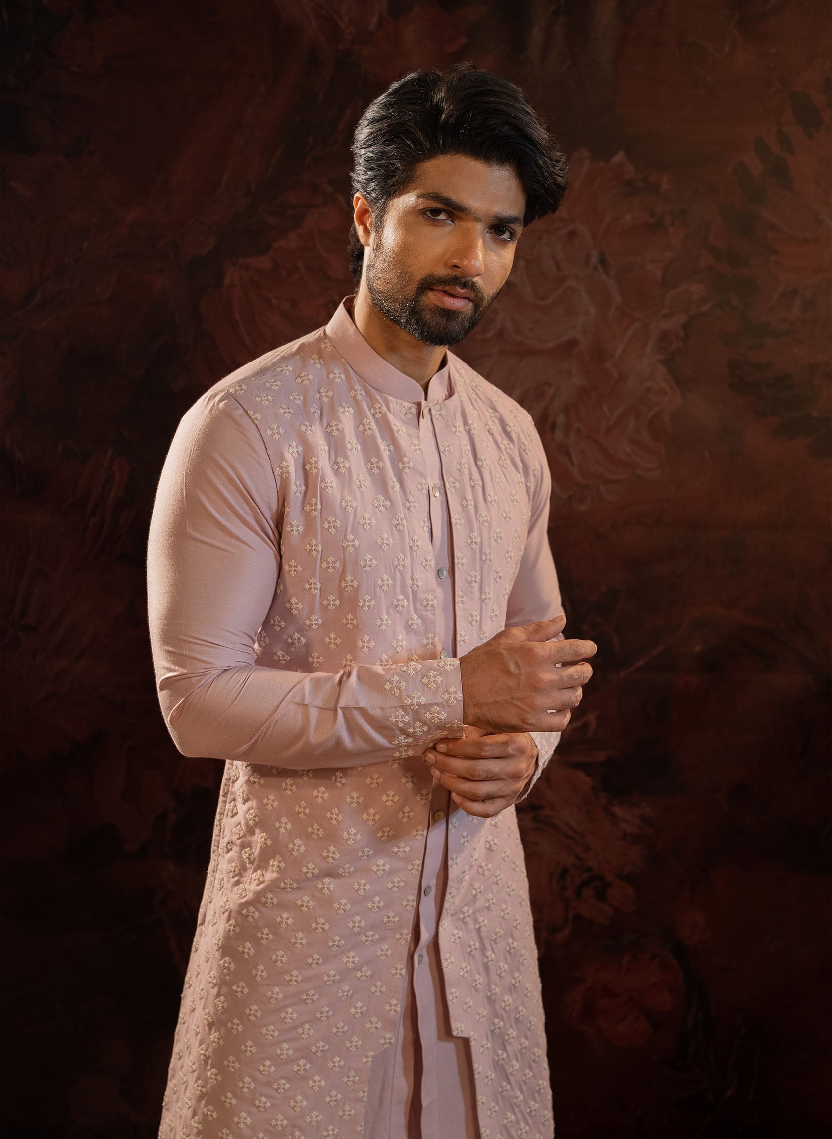 Lavender layered kurta set with front opening and embroidered floral motifs. Embroidery detailing on cuffs and back. Comes with straight pants with two side pockets and zip opening.