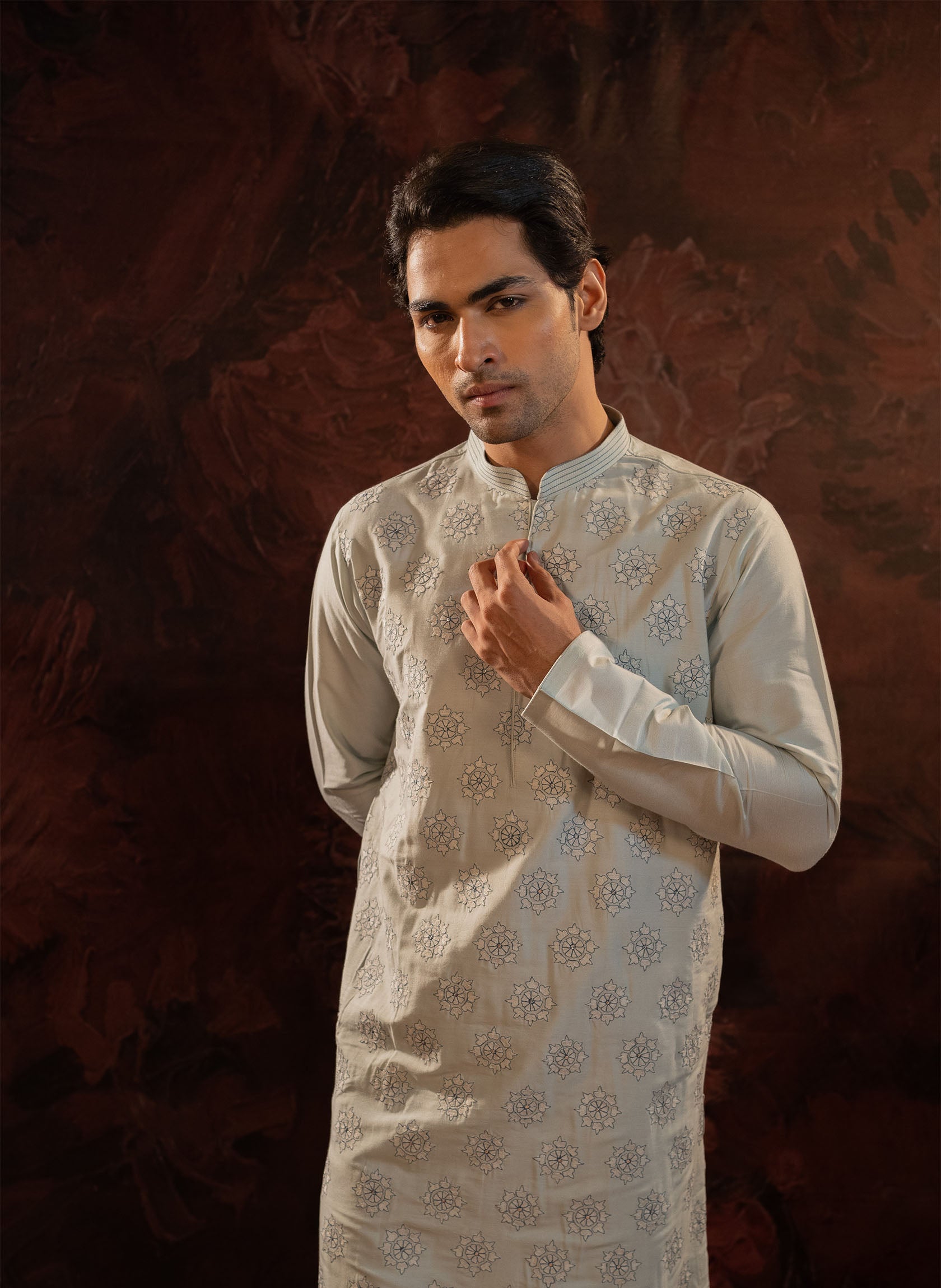 Powder blue cotton silk kurta set with floral embroidered motifs all over. Stitchline detailing on the collar. Comes with churidar.