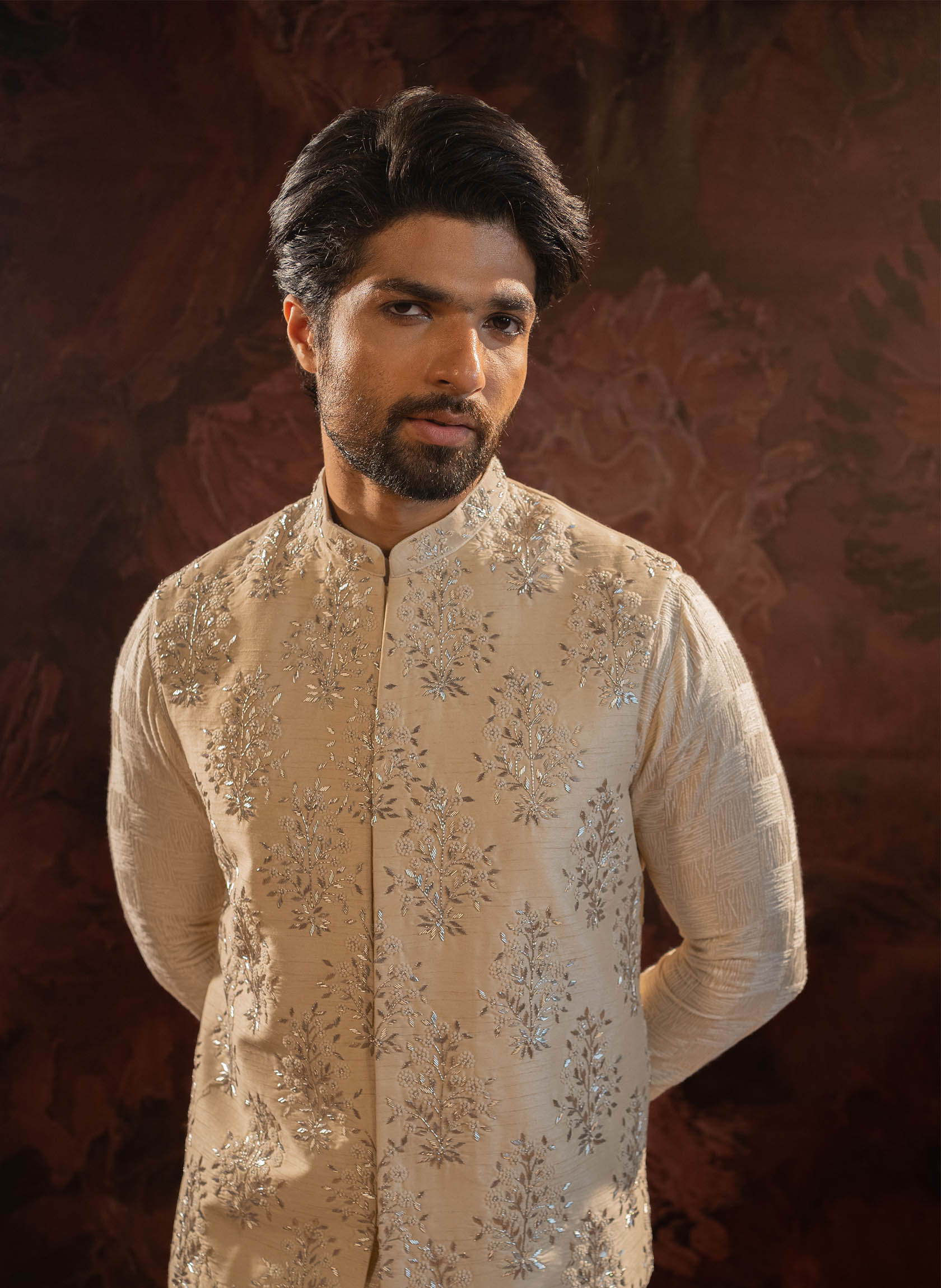 Ivory silk jacket with floral motifs in silver zari. Comes as a set with Offwhite Kurta set with all over abstract embroidery in tone on tone hues and churidar.