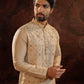 Beige Silk Kurta with all over hand done french knot embroidery with mustard and maroon highlights. Comes with Churidar.