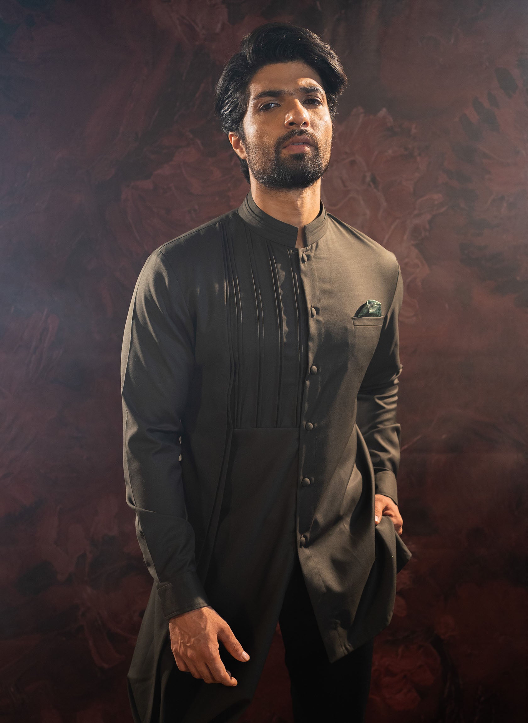 Olive green short kurta with asymnmetric cowl pattern and broad cuffs. Comes with black straight pants.